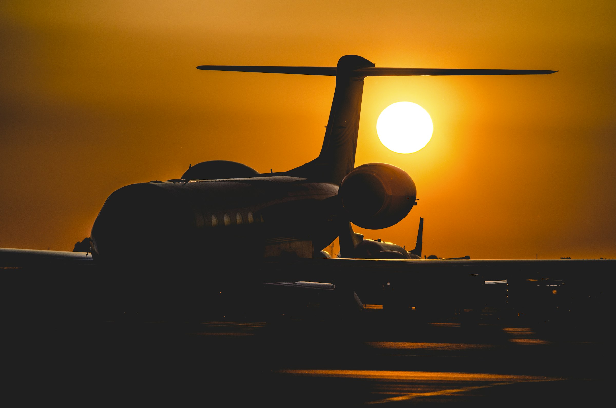 Sunset sky over an East African travel route, an aircraft silhouette in view.